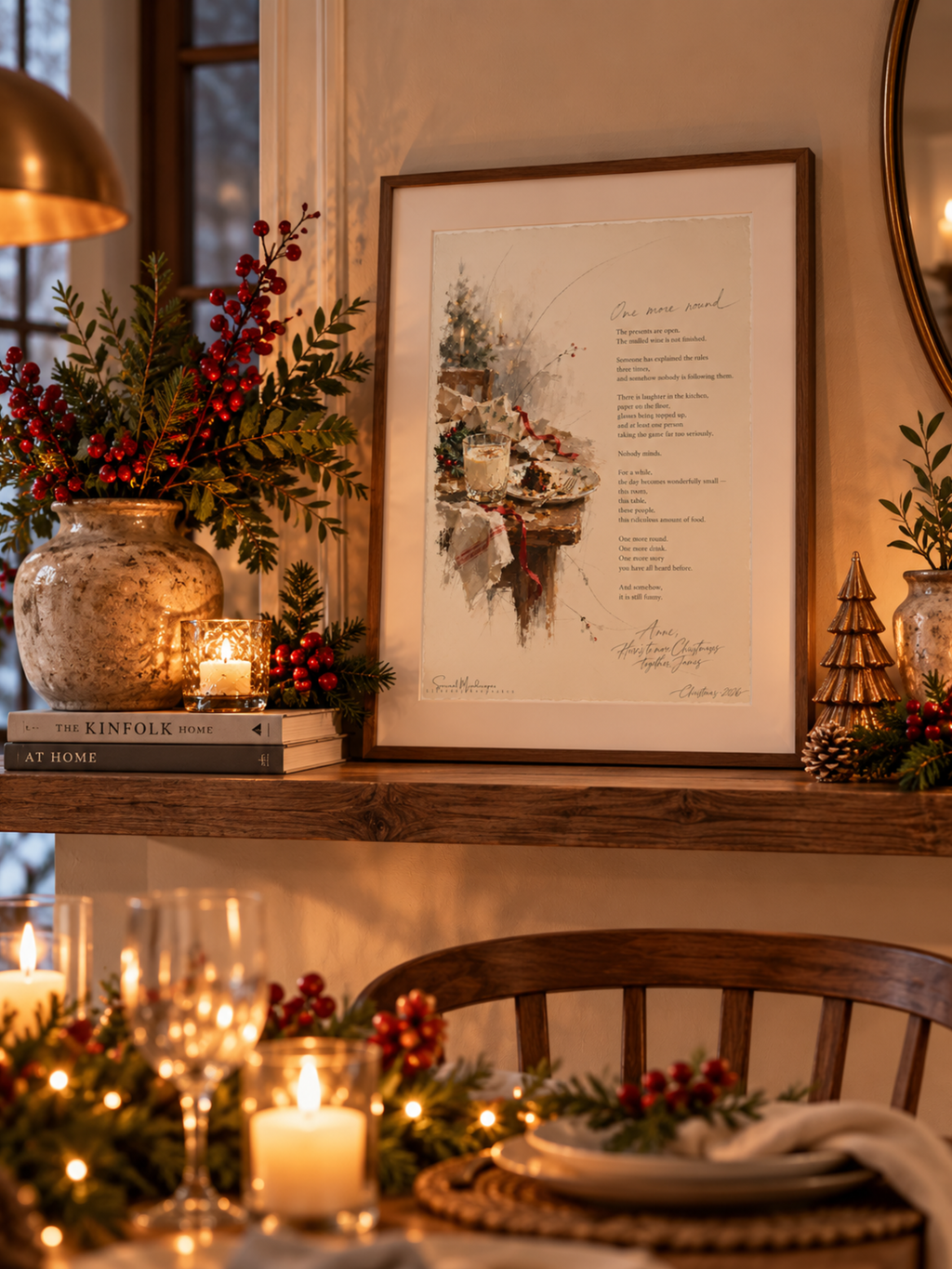 One More Round framed Christmas poetry print displayed on a wooden mantelpiece with festive greenery, candles and warm Christmas lights.